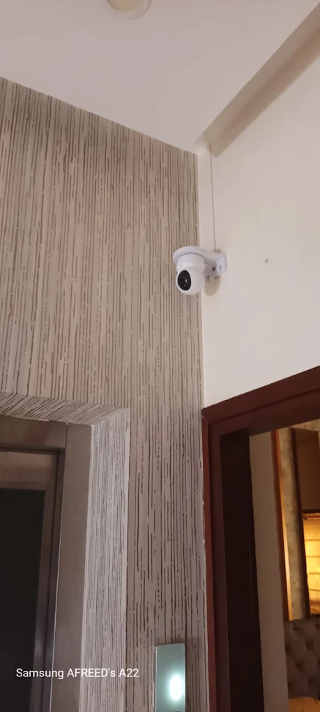 Dome CCTV camera installed high on an interior wall